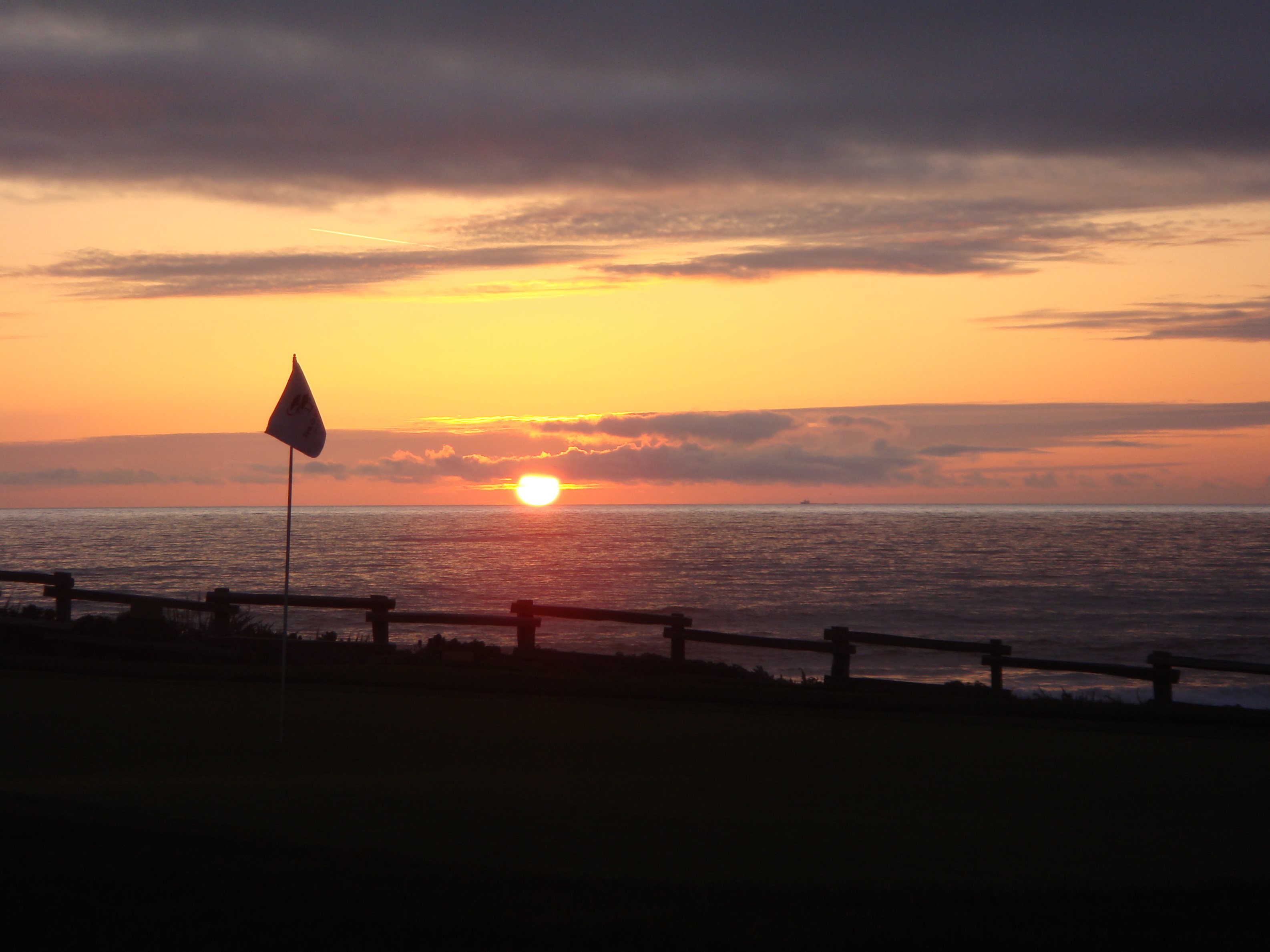 Sunset over the 18th green at Half Moon Bay golf course