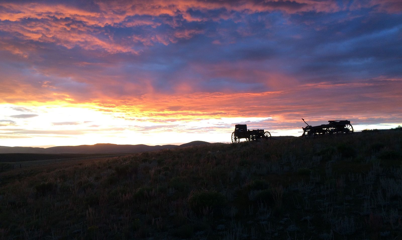 Wagons silhouetted against the sunset on the Quarter Circle Circle ranch